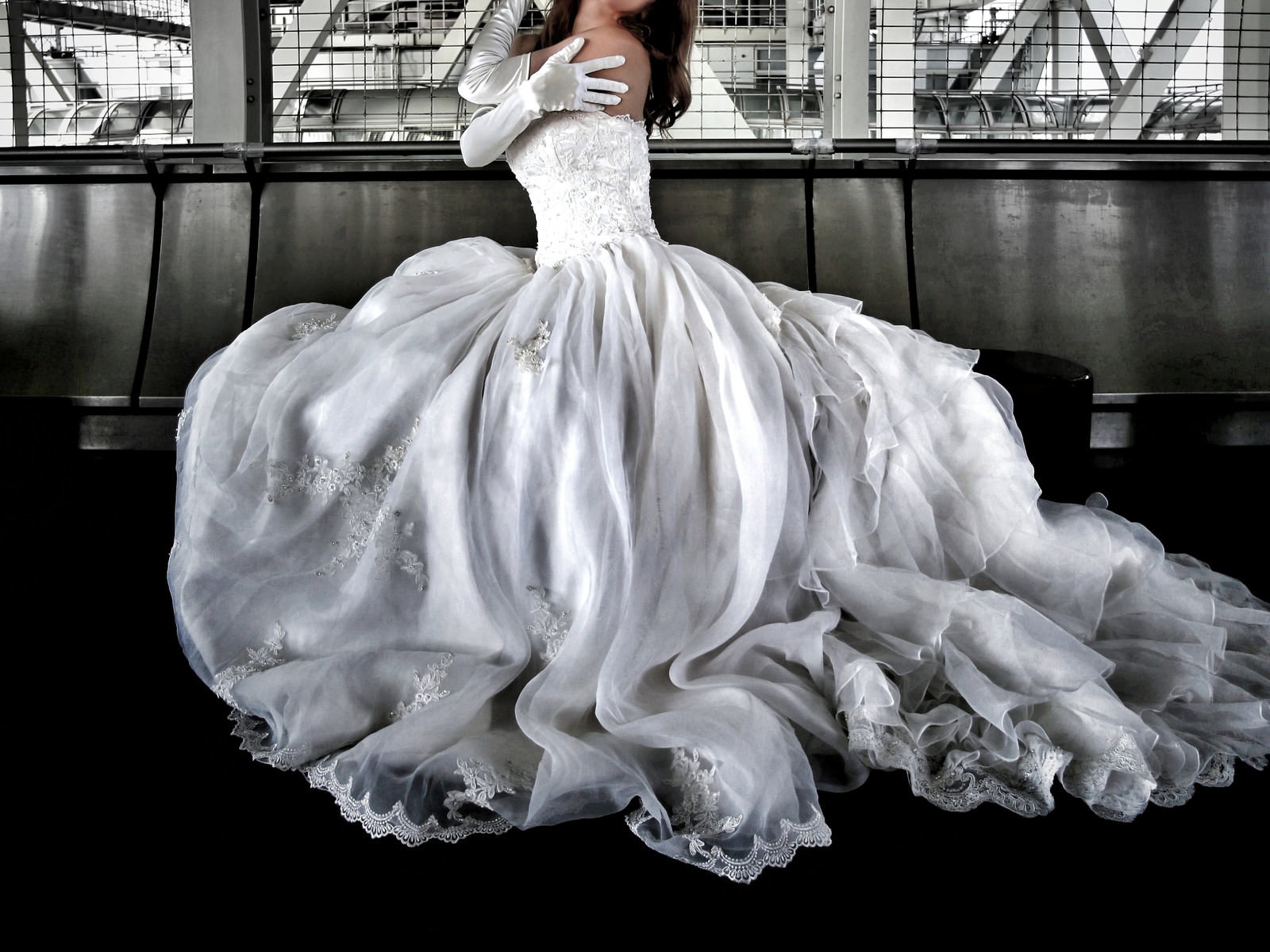 陸橋下でウェディングドレスを着て座っている女性［モデル：モデルリリース］