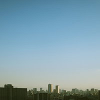 都会のマンション群が並ぶ朝焼けの空と都市景観の写真