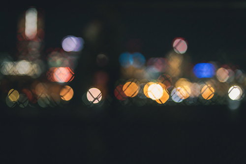 フェンス越しに見た街のライトアップと丸ボケ