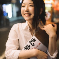 泥酔と書かれた一升瓶抱き枕をプレゼントされご満悦の泥酔女子の写真