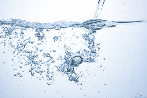 注がれる少量の水と浮かぶ気泡の水中風景