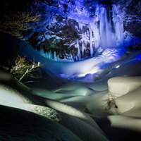 青紫色にライトアップされた平湯大滝の結氷の写真