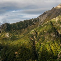 奥丸山から望む北アルプス槍ヶ岳と雲海に浮かぶ槍ヶ岳山荘の写真