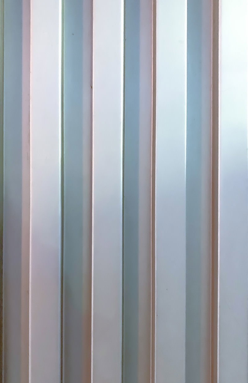 Metal plate with orderly vertical striped pattern in silver and gray tones