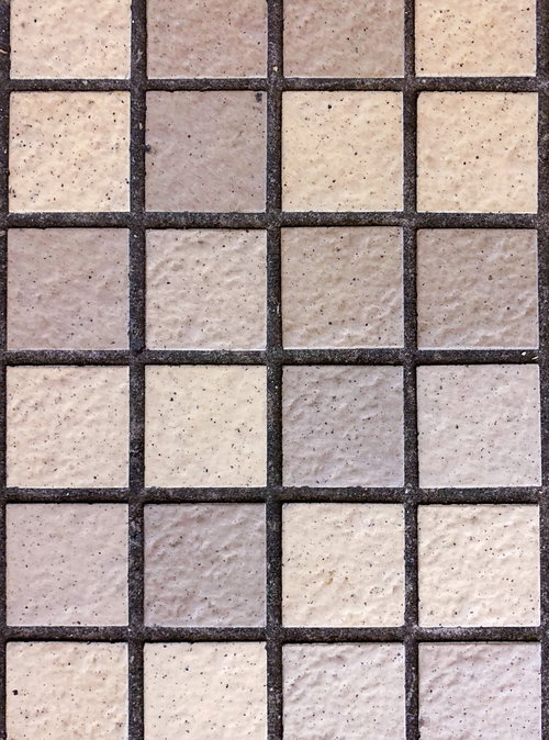 ベージュ系の正方形ミニタイル床のテクスチャー