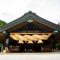 出雲大社の神楽殿と大きなしめ縄の全景と参拝風景の写真