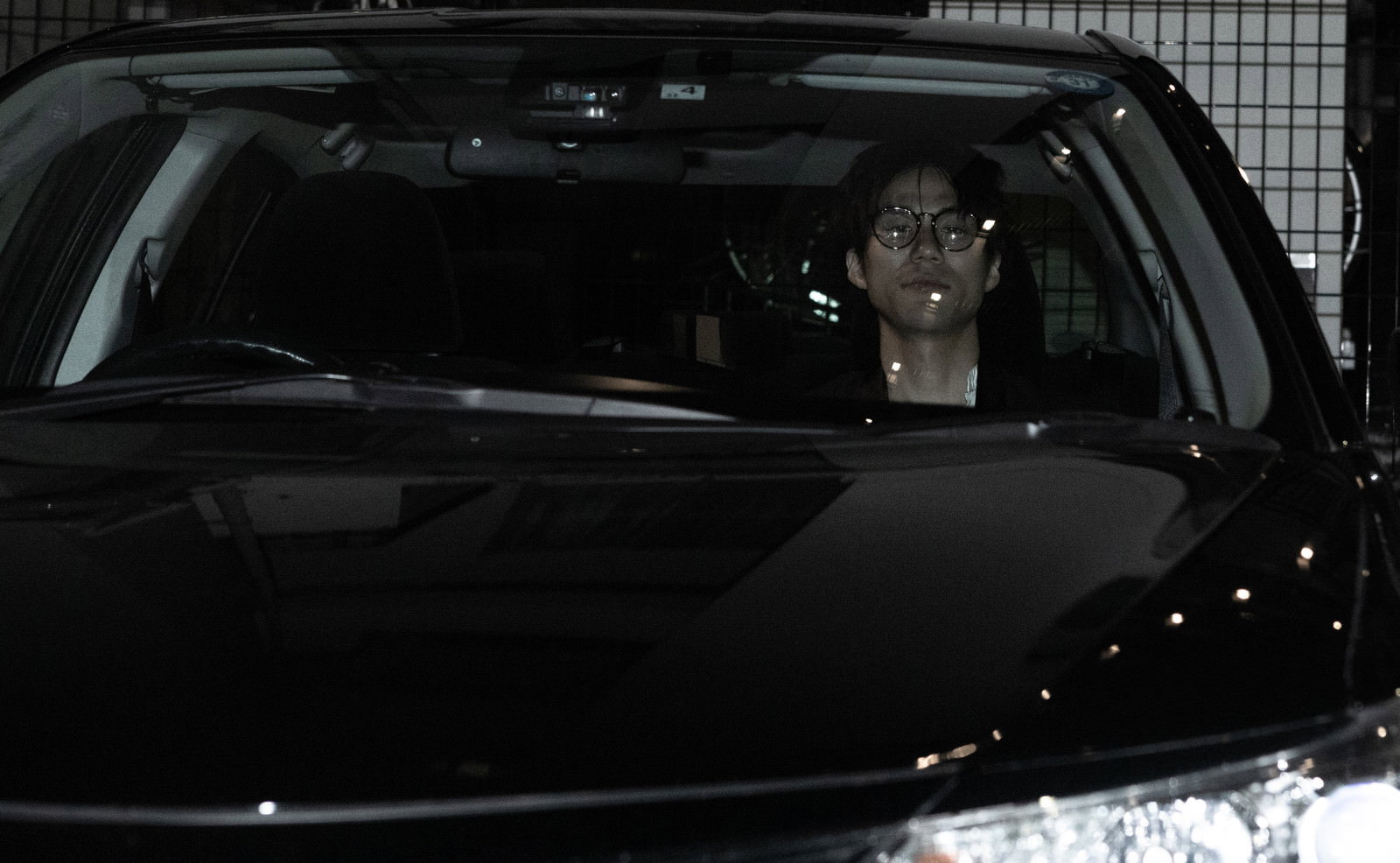A man waiting in the passenger seat for the driver to return