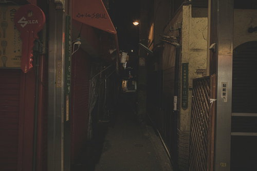 閉店時間の薄暗い路地裏のシャッター通り、夜の街角風景