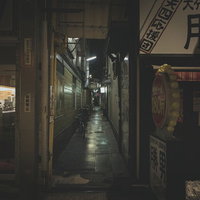 薄暗い路地裏の道、閉店したシャッター街の夜間風景の写真