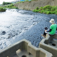 川の流れにデータの流れを重ねて想いを馳せるマーケターの写真