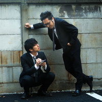 高圧的な態度でお金を借りる上司と貸した金額をメモする部下の写真