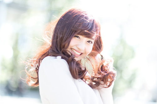 春の陽光に包まれてはしゃぐ彼女のロングヘアーと笑顔