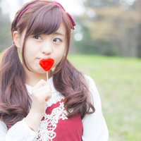 ハートキャンディを持つそわそわガール in 公園の写真