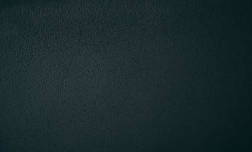 暗闇の中のネイビーカラーの壁テクスチャー