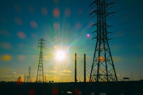 夕焼けに浮かぶ鉄塔と送電線のシルエット