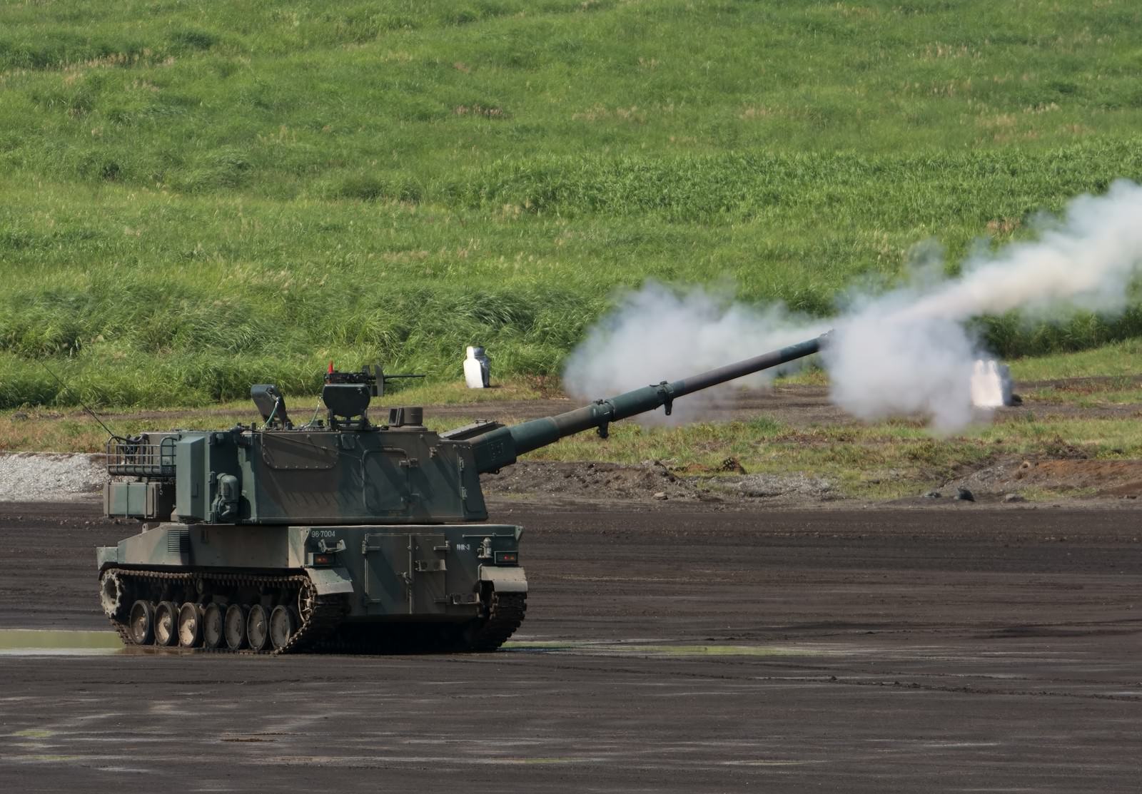 Type 99 self-propelled howitzer firing with smoke from barrel