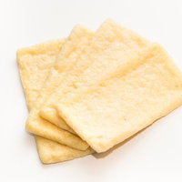 調理前の黄色いあぶらあげ、淡い色合いが特徴の豆腐揚げの写真