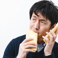 油揚げの音を聞きながら味見をする大豆マニアな男性の写真