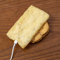 充電中の油揚げ 充電ケーブルが刺さったユーモアな食材の写真