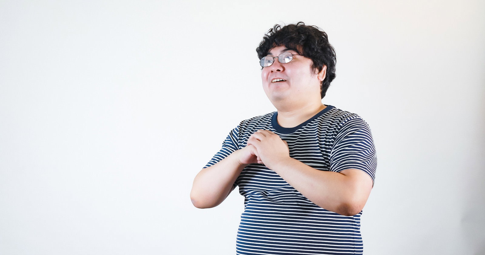 拳を構えて怒りの表情を見せる男性［モデル：段田隼人］