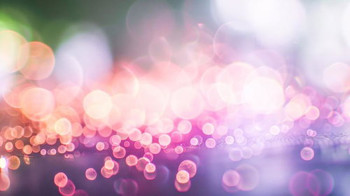 ピンク系グラデーションで輝く大中小の光の粒の煌めき