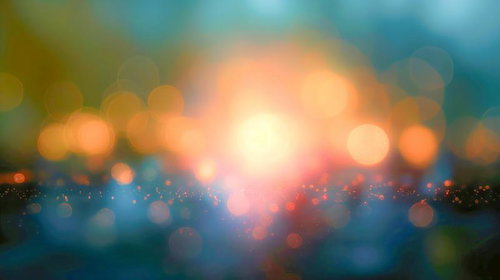 ぼんやりとしたオレンジ色の光源と玉ボケが広がる夜景