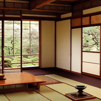 和室の窓から見える庭園の松と畳敷きの景観の写真