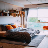 モダンなワンルームのベッドと本棚のある寝室の写真