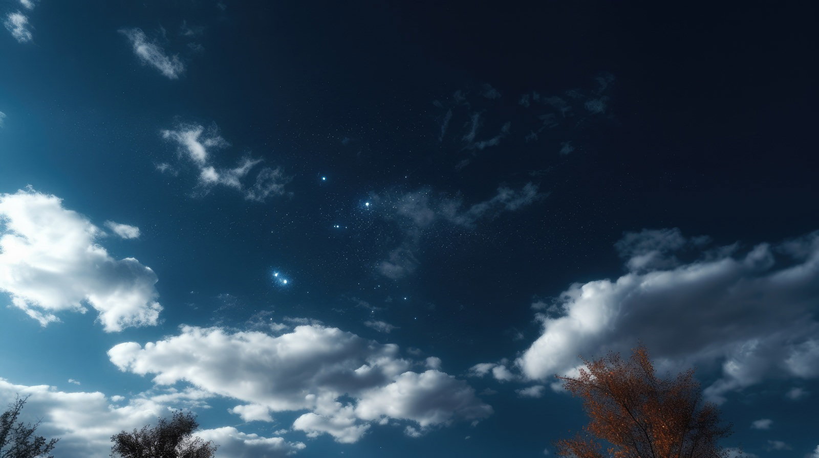 青い夜空に浮かぶ白く輝く星と雲の風景
