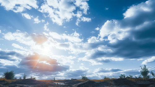 雲ひとつの青空と夕方の原っぱに差す日光と太陽の光