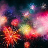 夜空に打ち上がる色とりどりの花火が光の粒子とともに広がるの写真