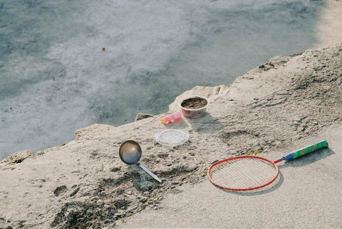 砂場での遊び道具とラケット、バケツやシャベルなどの子供向けおもちゃ