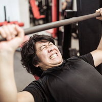 インクラインベンチプレスで大胸筋上部を鍛える男性トレーニーの写真