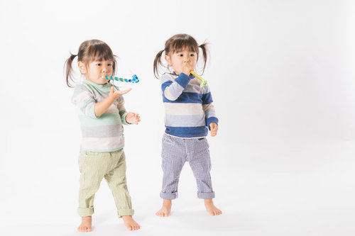 与えられたピロピロプーに夢中な子供（双子）