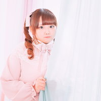 ピンクのカーテンに映えるツインテールのゆるふわ女性の写真