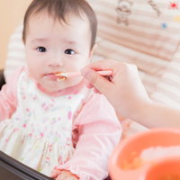離乳食をなかなか食べてくれない愛娘との食事の時間の写真