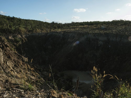 荒れ地にぽっかりと口を開けている硫黄島旧噴火口（ミリオンダラーホール）