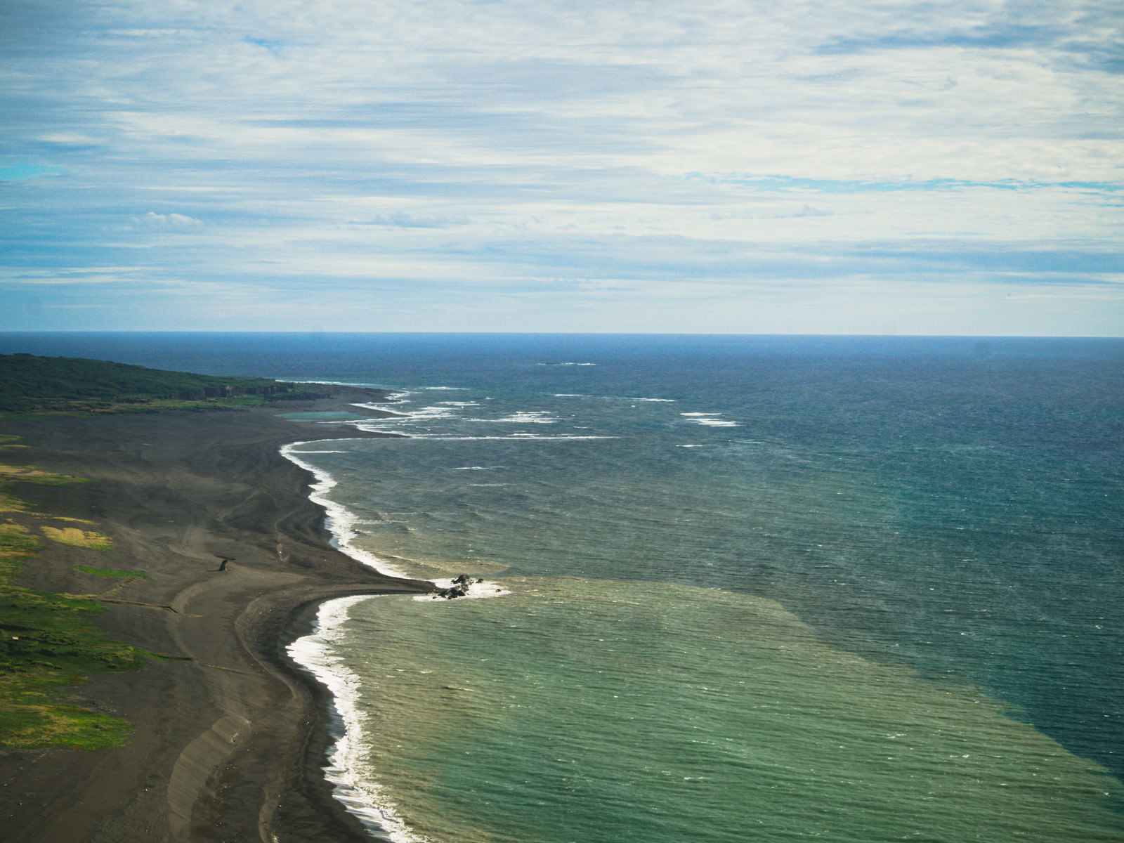 硫黄島の摺鉢山から望む上陸海岸、手前の二ツ根浜と奥の翁浜