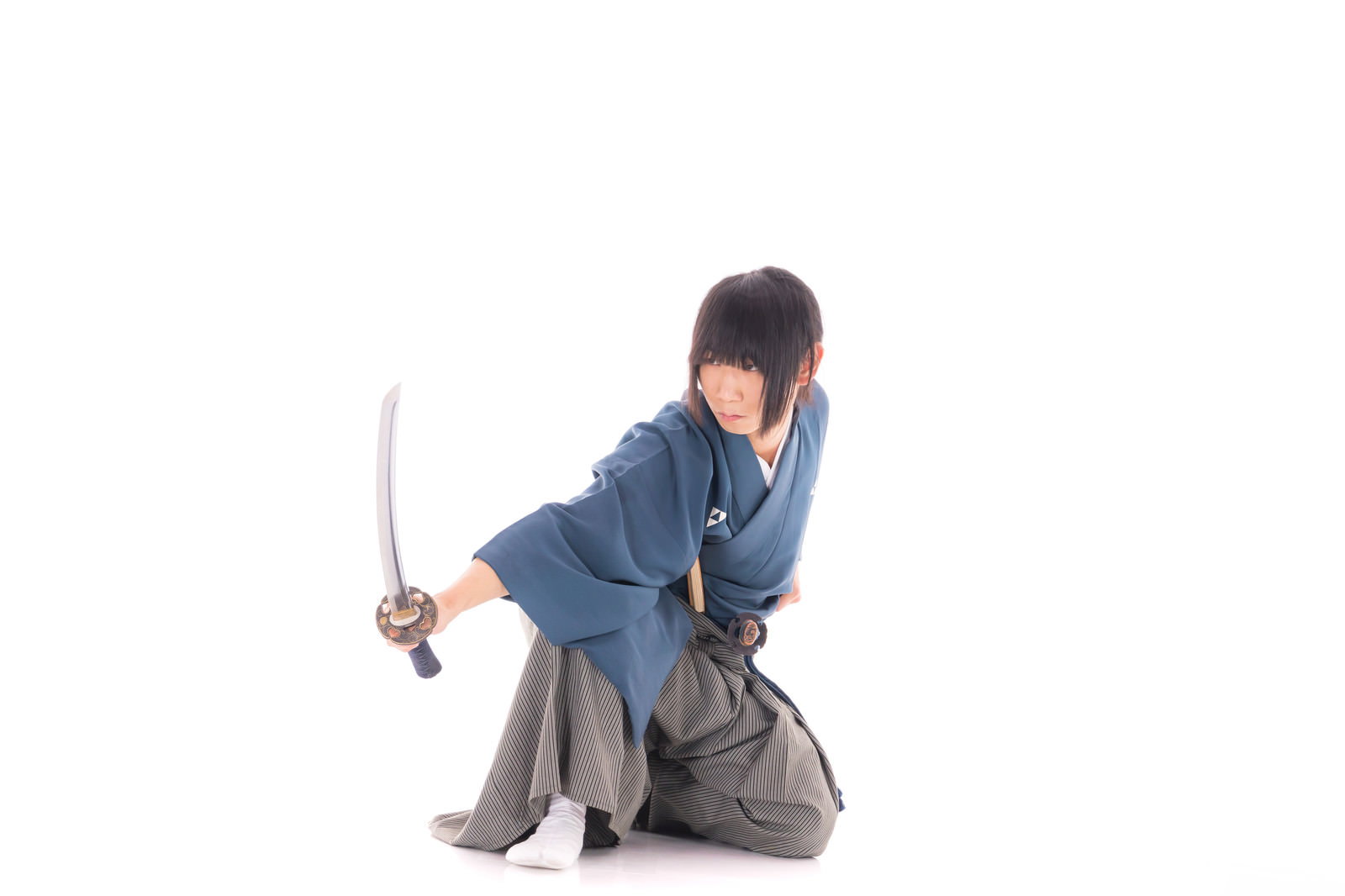 紺色の着物と袴姿で打刀を構える侍の姿［モデル：まーこ］