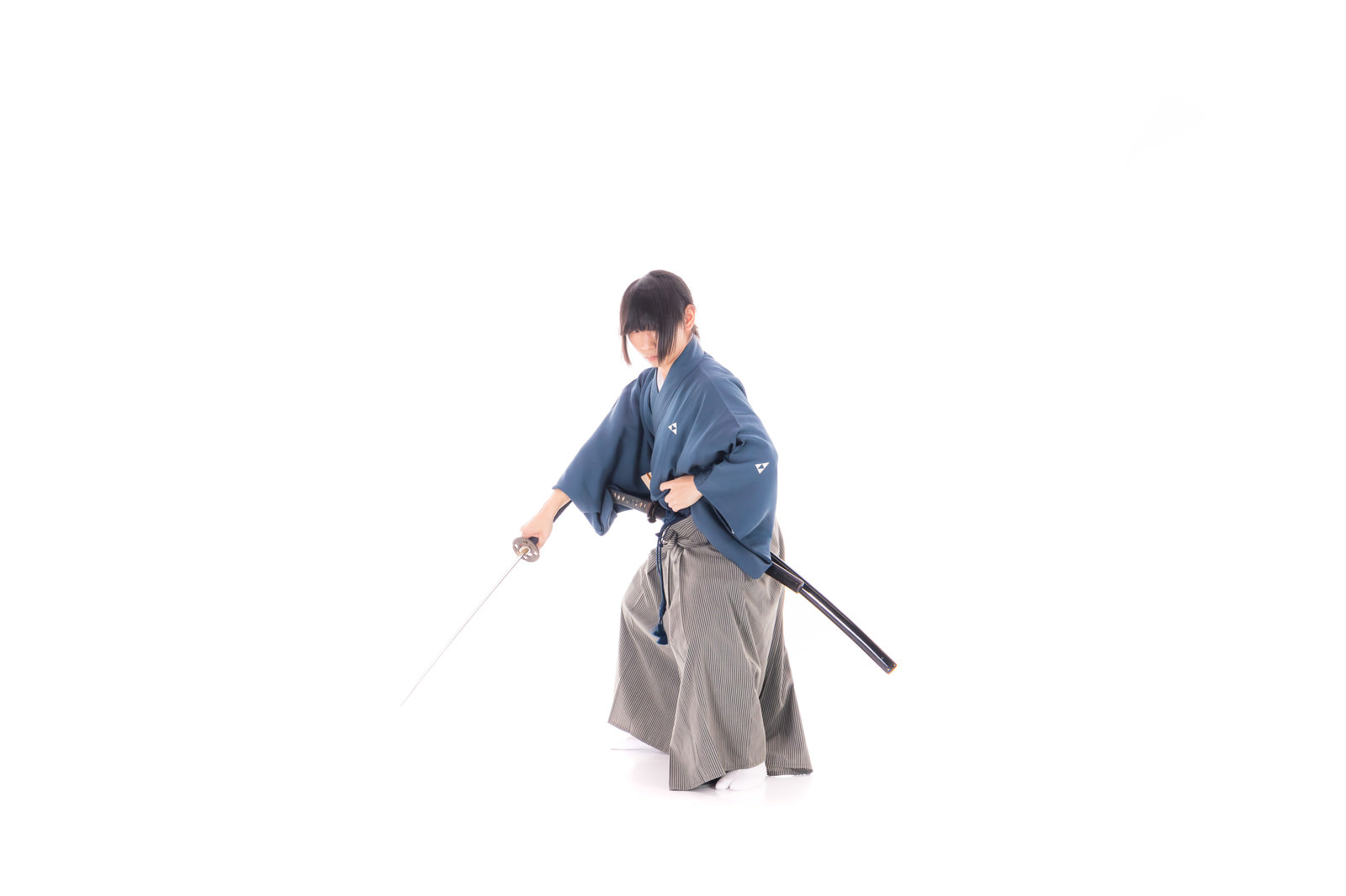 紺色の着物と灰色の袴を着た侍が日本刀を両手で構えている［モデル：まーこ］