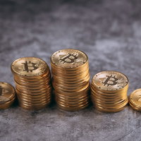 棒グラフ上に積み上げた金貨のビットコインの写真