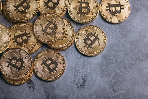 グレーの背景に無造作に置かれたビットコイン