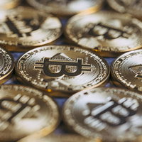 ビットコインコインが並ぶ金色の背景の写真