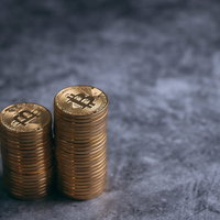 積み上げた金貨ビットコインの2つのコインの山の写真