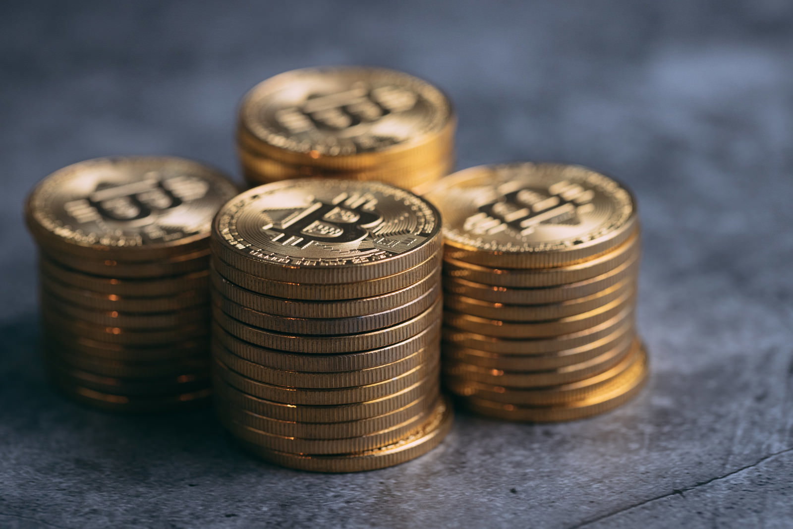 金色のビットコインコインが複数積み重ねられている様子