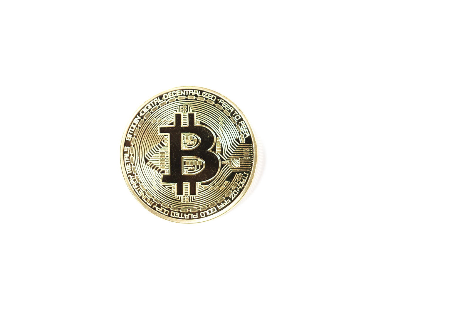 白い背景に置かれたゴールドカラーのビットコインコイン