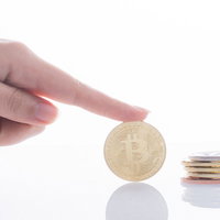 ビットコインで積立投資する手とコイン、長期的な資産運用の写真