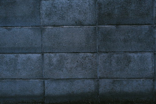 経年劣化したグレーのコンクリートブロック塀