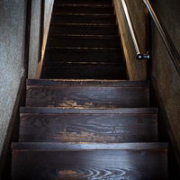 古い木造家屋の急な階段の写真