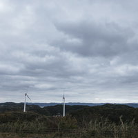 北緯33度線展望台から眺める風力発電機と山々の景色の写真